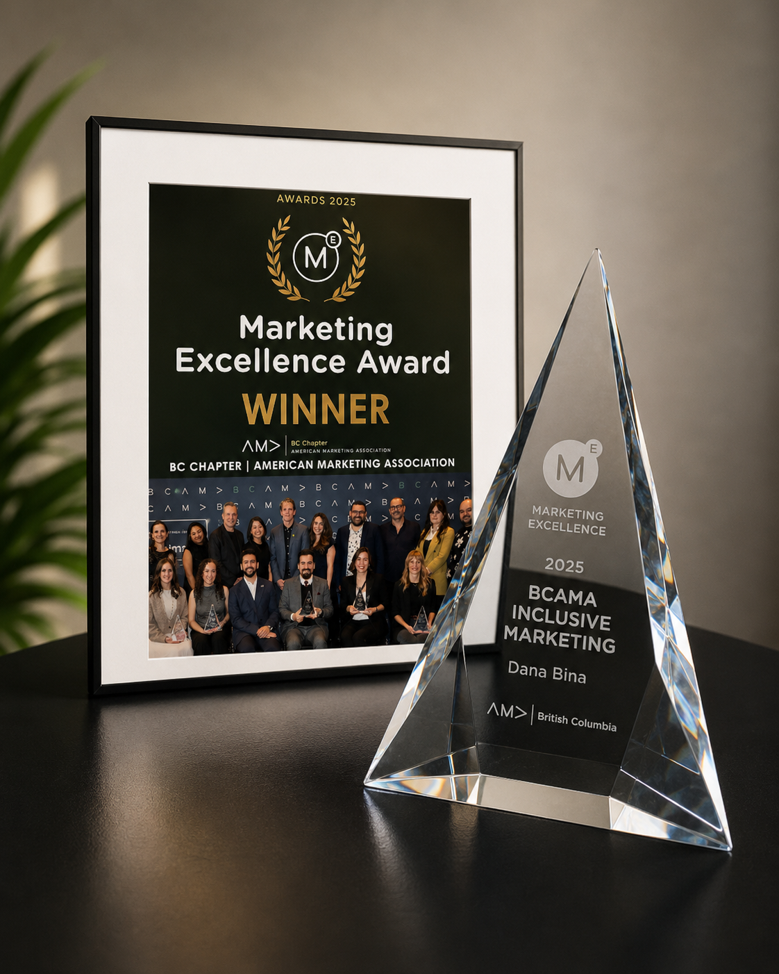 BCAMA Marketing Excellence Award 2025 crystal trophy engraved for Dana Bina, beside the framed winner announcement