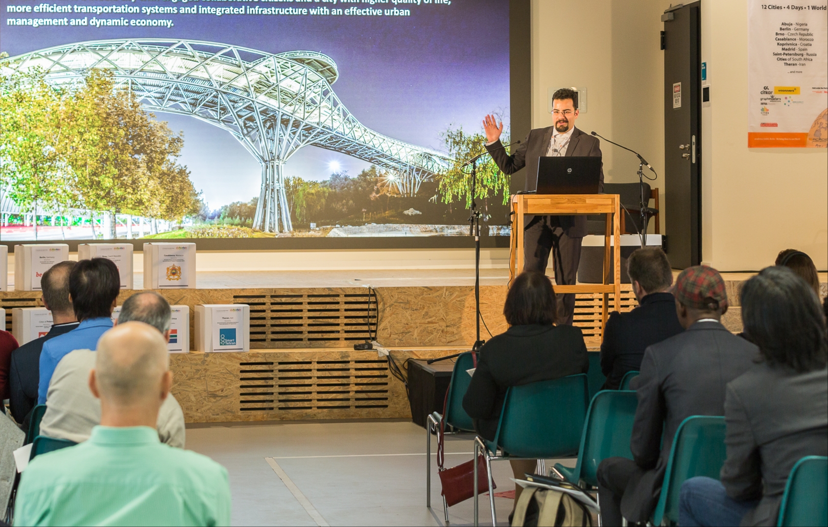 Dana Bina delivering a keynote on the Smart Tehran vision to a seated international audience at the International Smart City Dialogue in Berlin