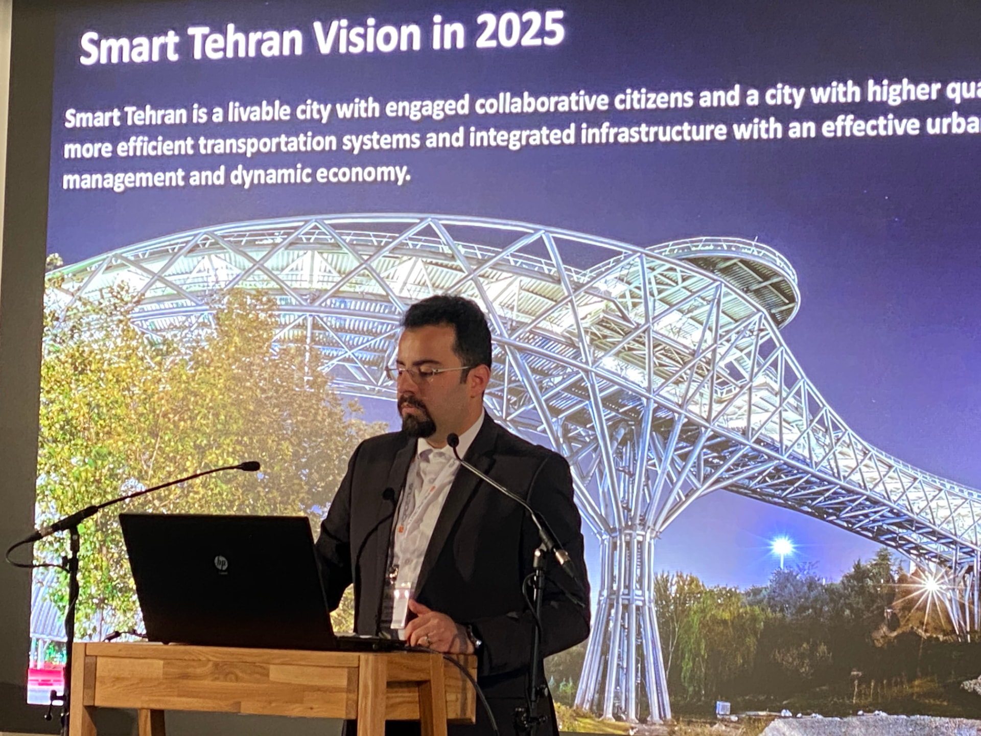 Dana Bina presenting the Smart Tehran Vision 2025 smart-city strategy slide during an international conference keynote