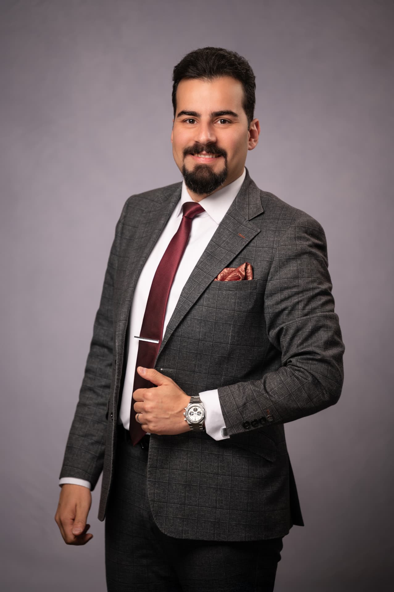 Executive portrait of Dana Bina in a grey check suit